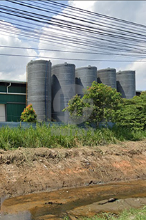 External view of multiple FRP closed top tanks at Ramly Food Processing Factory, showcasing large-scale storage capabilities.