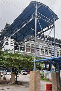 FRP Covered Walkway at Commercial Complex – Large blue FRP canopy structure installed at a commercial site entrance for pedestrian protection.