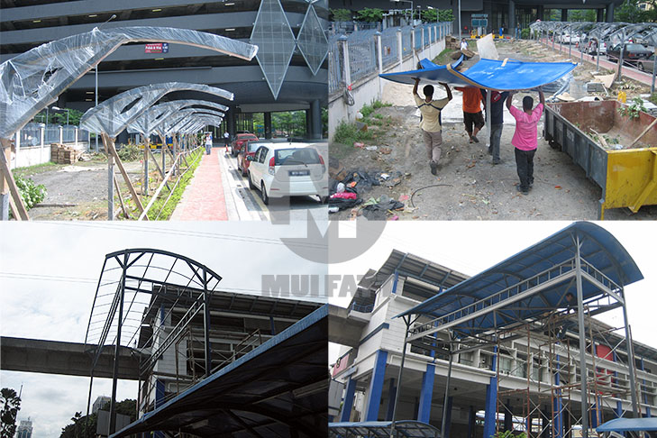 FRP Walkway Installation Progress – Workers assembling FRP walkway roofing structure with blue roofing near Taman Jaya LRT station parking lot.