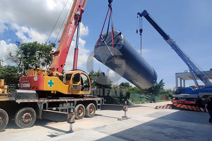 Horizontal FRP tank being positioned with cranes at Ramly Food Processing Factory for industrial liquid storage.