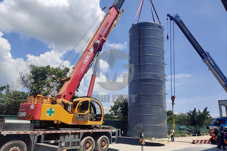 Installation of a vertical FRP storage tank at Ramly Food Processing Factory using cranes for efficient handling.