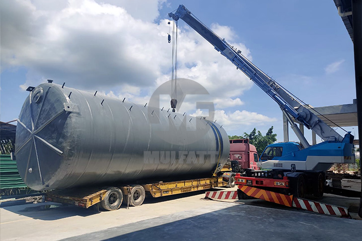 Large FRP storage tank being transported at Ramly Food Processing Factory, highlighting durable and lightweight material.