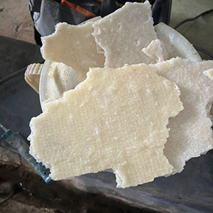 Peeled off debris from the delaminated internal wall of an FRP tank