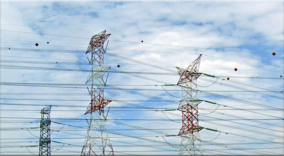 Transmission tower near KLIA toll exit, equipped with aircraft warning spheres for enhanced visibility and aviation safety