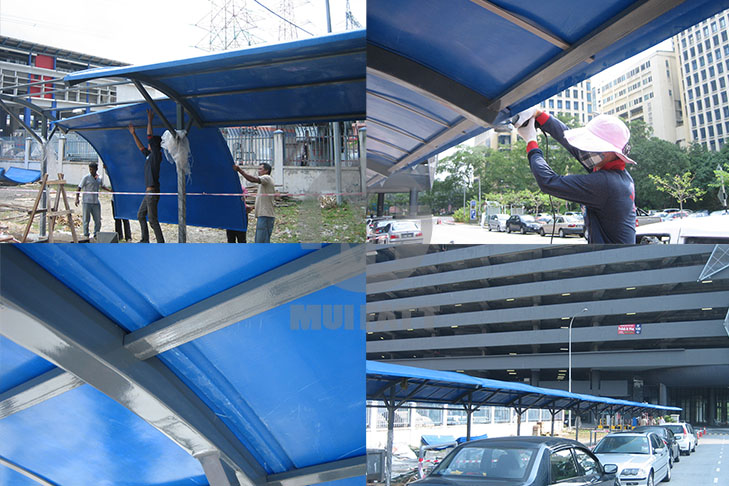 Workers Installing FRP Roof Panels – Team lifting and securing fiberglass reinforced plastic (FRP) roofing solid sheets for pedestrian walkway.